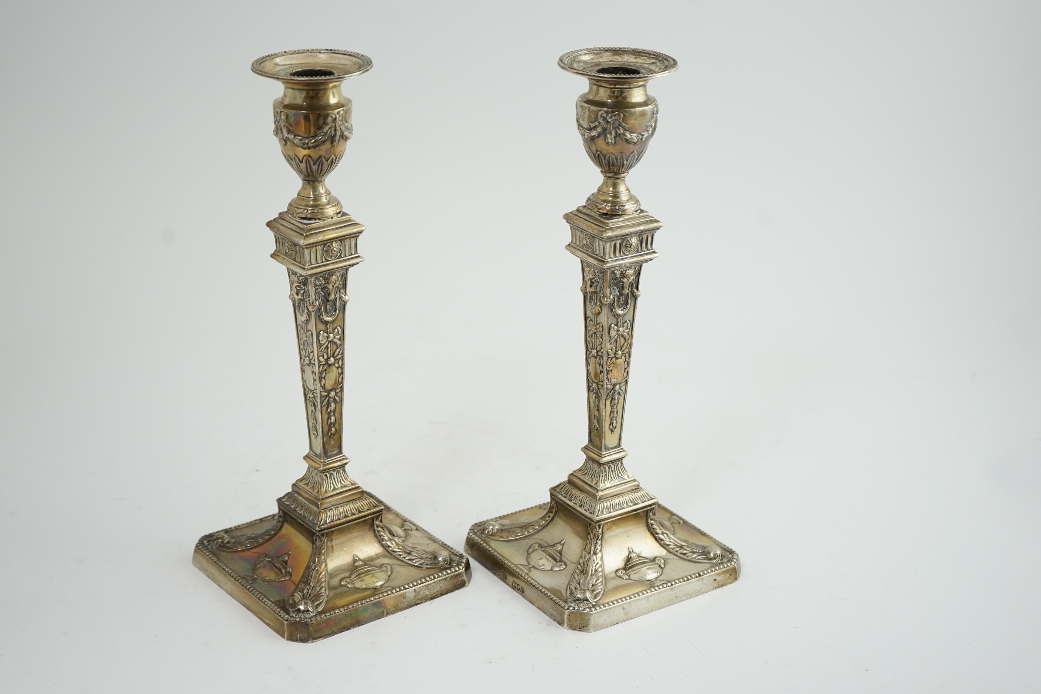 A pair of late Victorian silver Adam style candlesticks, by William Hutton & Sons, (a.f.)